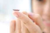 Contact lens on a fingertip